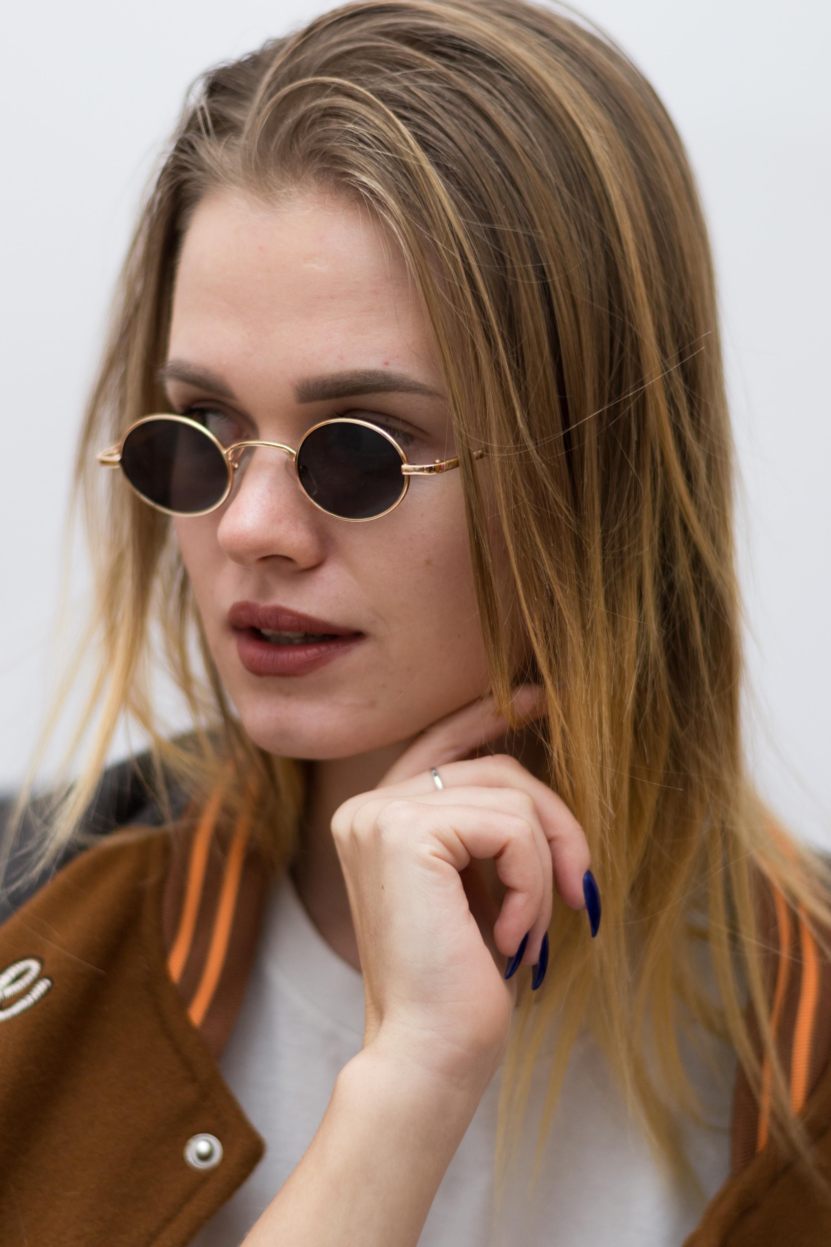 Woman In Sunglasses Posing On White Wall Background Free Stock Photo Woman in sunglasses posing on white wall background free stock photo