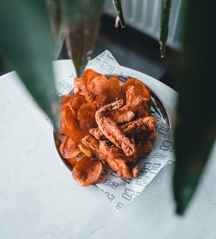 Close-up Of Chicken And Chips On A Plate