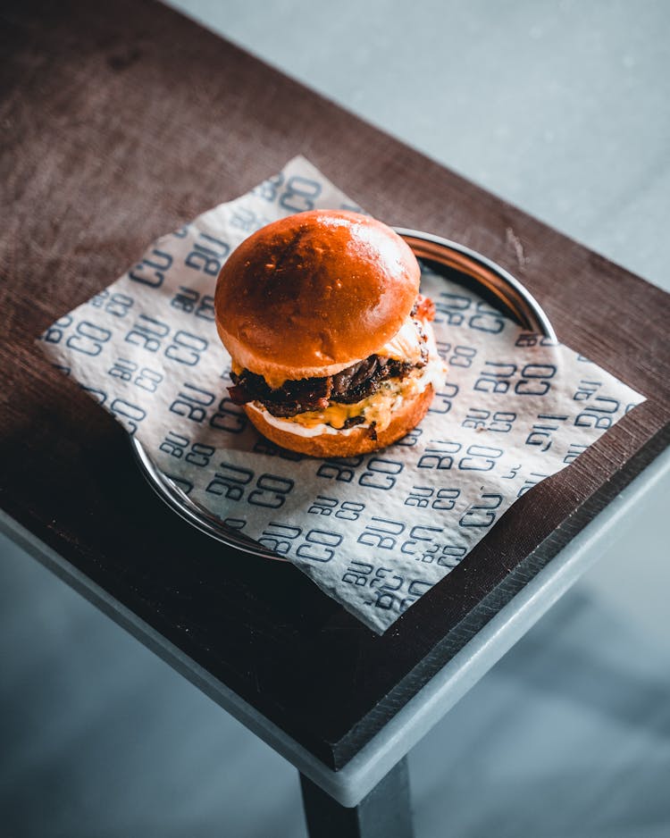 A Plate Of Cheeseburger On Table