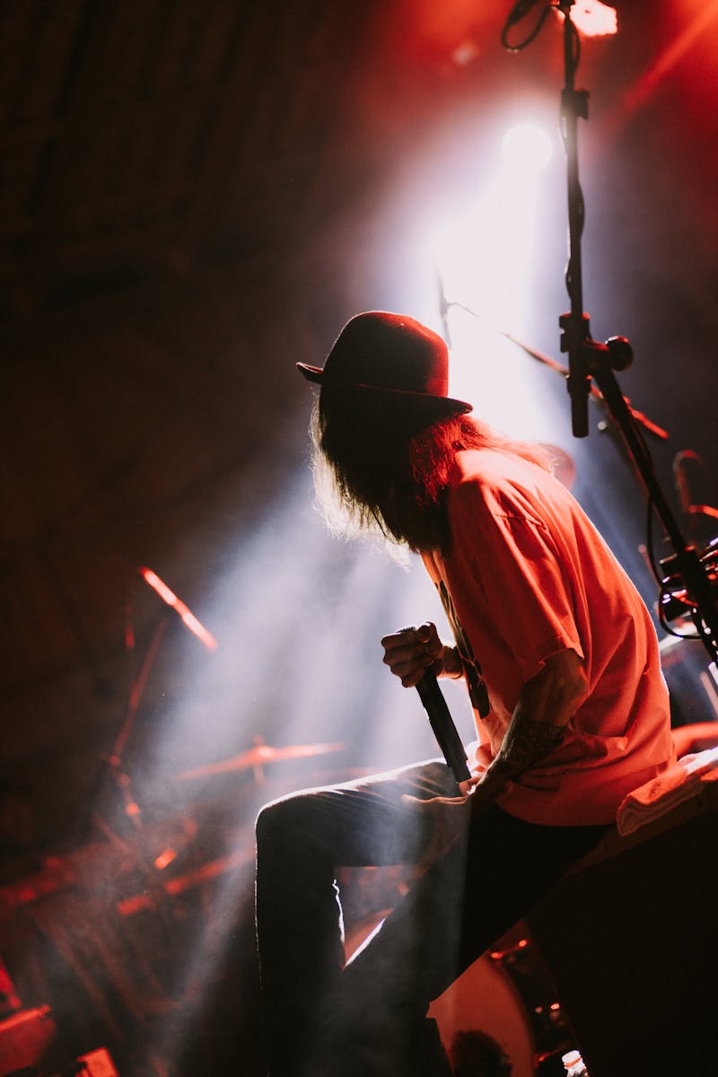 Singer in Red Dress Standing on Stage · Free Stock Photo