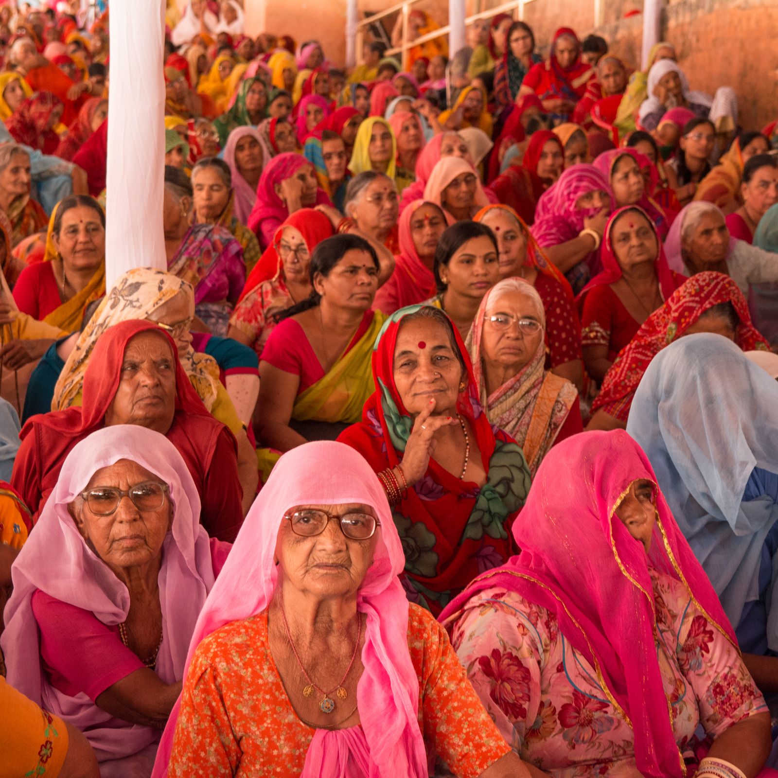 A large group of Indian women seated together, conveying community, listening, and shared support.