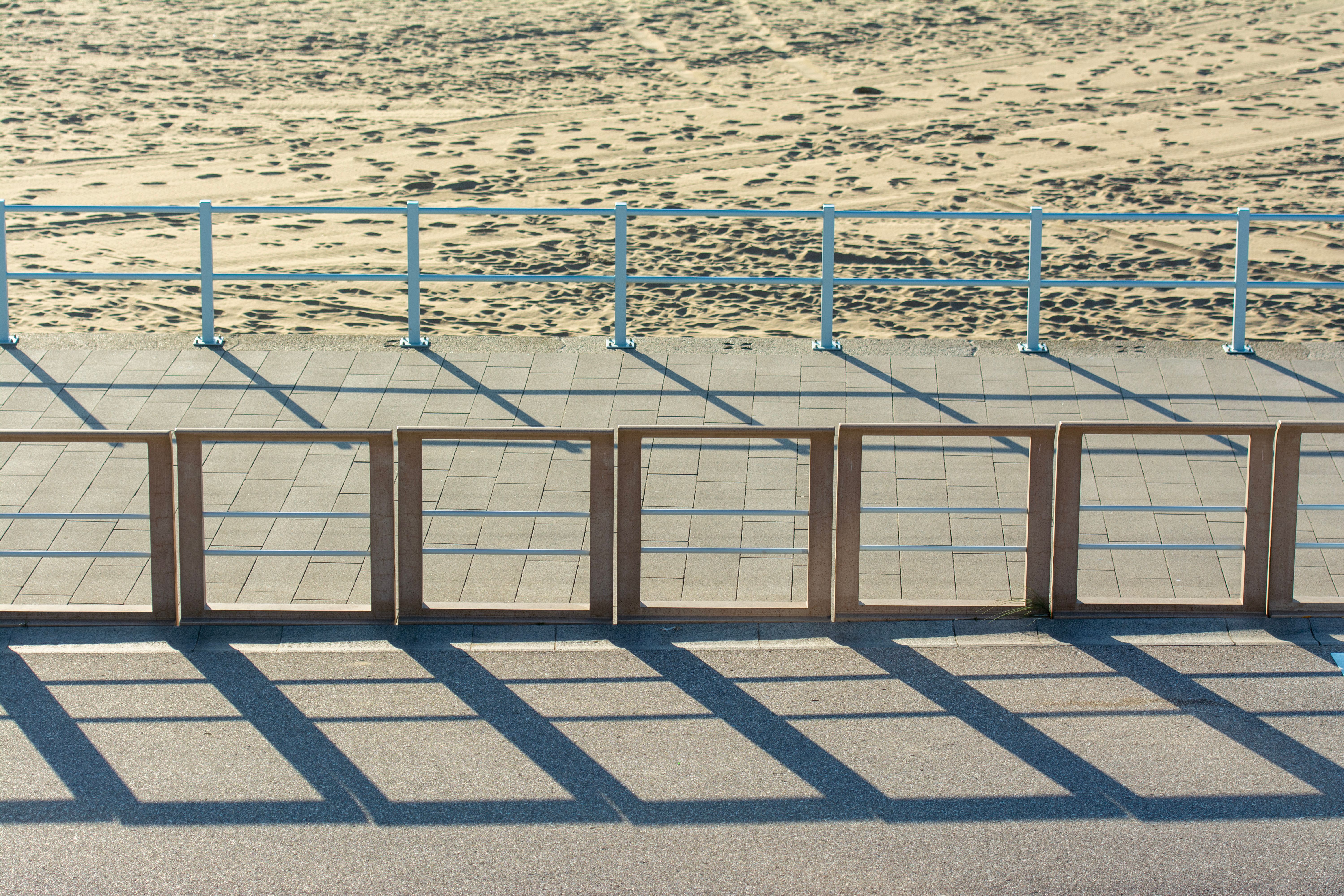 Railings on Empty Pavement on Beach · Free Stock Photo