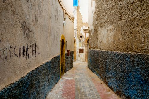 Free Explore the charm of a narrow alleyway in a historic old town with textured walls. Stock Photo