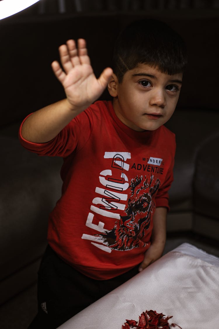 A Young Boy In Red Long Sleeves