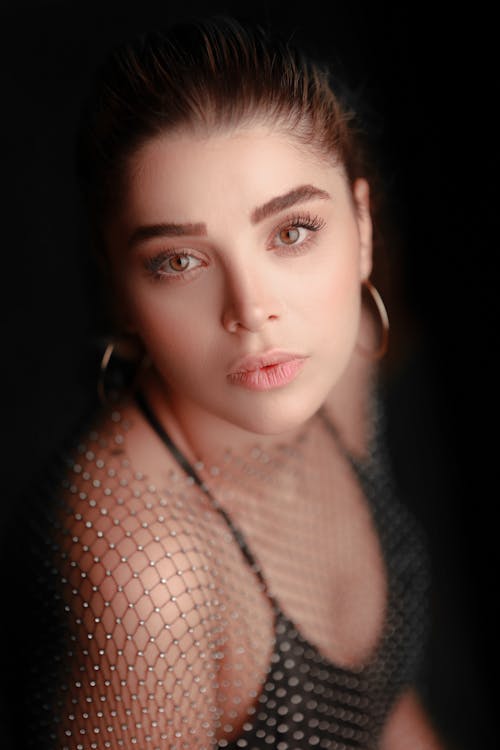 Photo of a Young Beautiful Woman With Earring and Wide Open Eyes