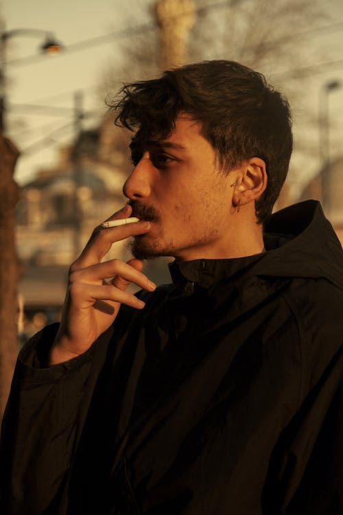 Man in Black Hoodie Jacket Smoking