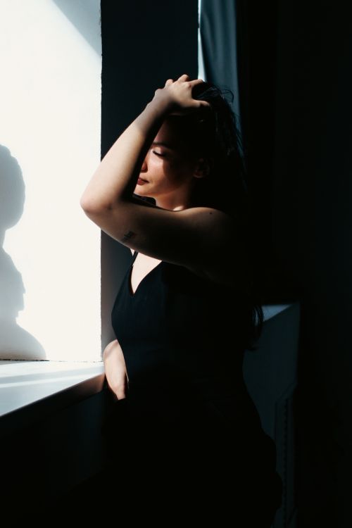 Woman Posing by Window in Darkness · Free Stock Photo