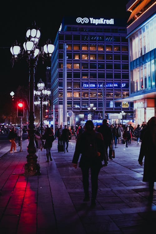 People Walking on City Street during Nighttime