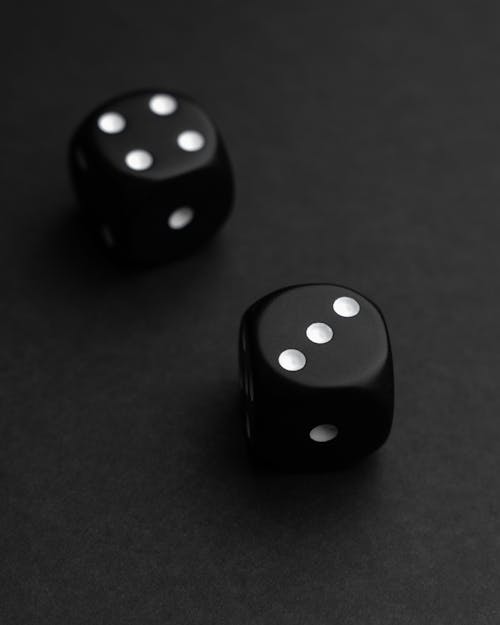 Close-up of a Pair of Dice on the Black Background 
