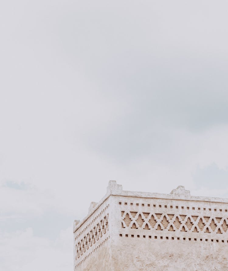 White Concrete Building Under White Sky