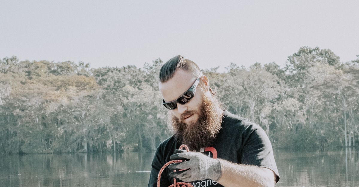 Untangling Ropes Man Untangling Rope on a Bridge · Free Stock Photo