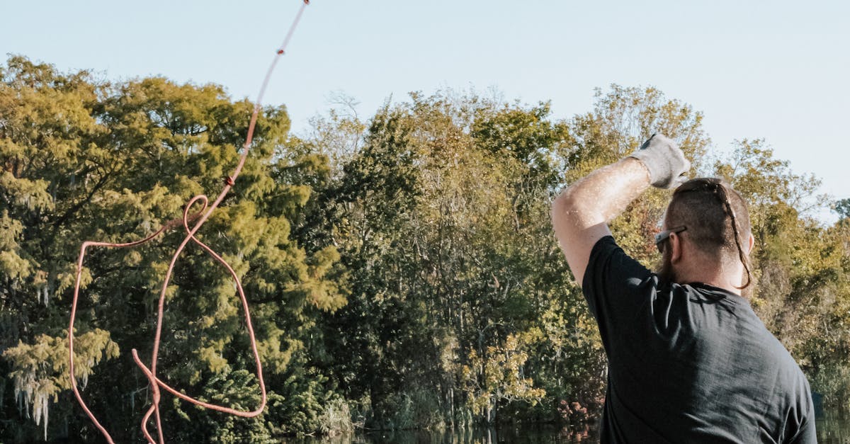 Man Throwing a Rope in the Lake · Free Stock Photo
