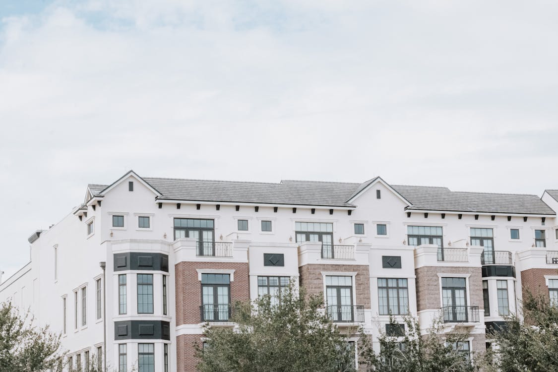 Facade of White Apartment Building Under White Sky