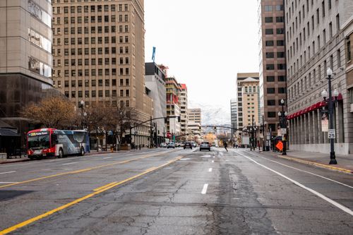Free A bustling downtown street with vehicles and tall buildings, showcasing urban life. Stock Photo