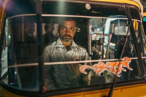 Free A man with a beard driving a traditional auto rickshaw in Pune, India. Stock Photo