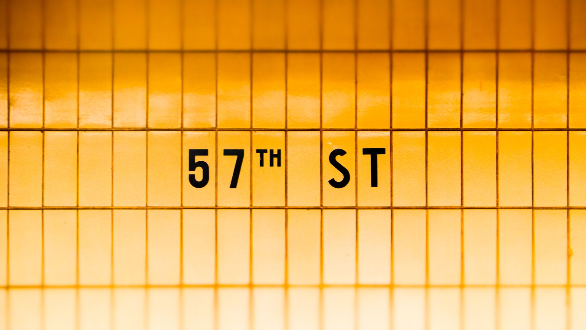 Close-up of 57th Street subway station tiled wall in New York City.