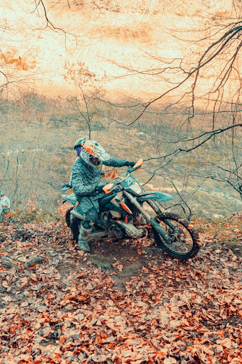 A Man Riding a Motorcycle on the Hill