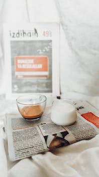 A warm, inviting still life featuring coffee and milk on a newspaper, ideal for a relaxing morning theme.