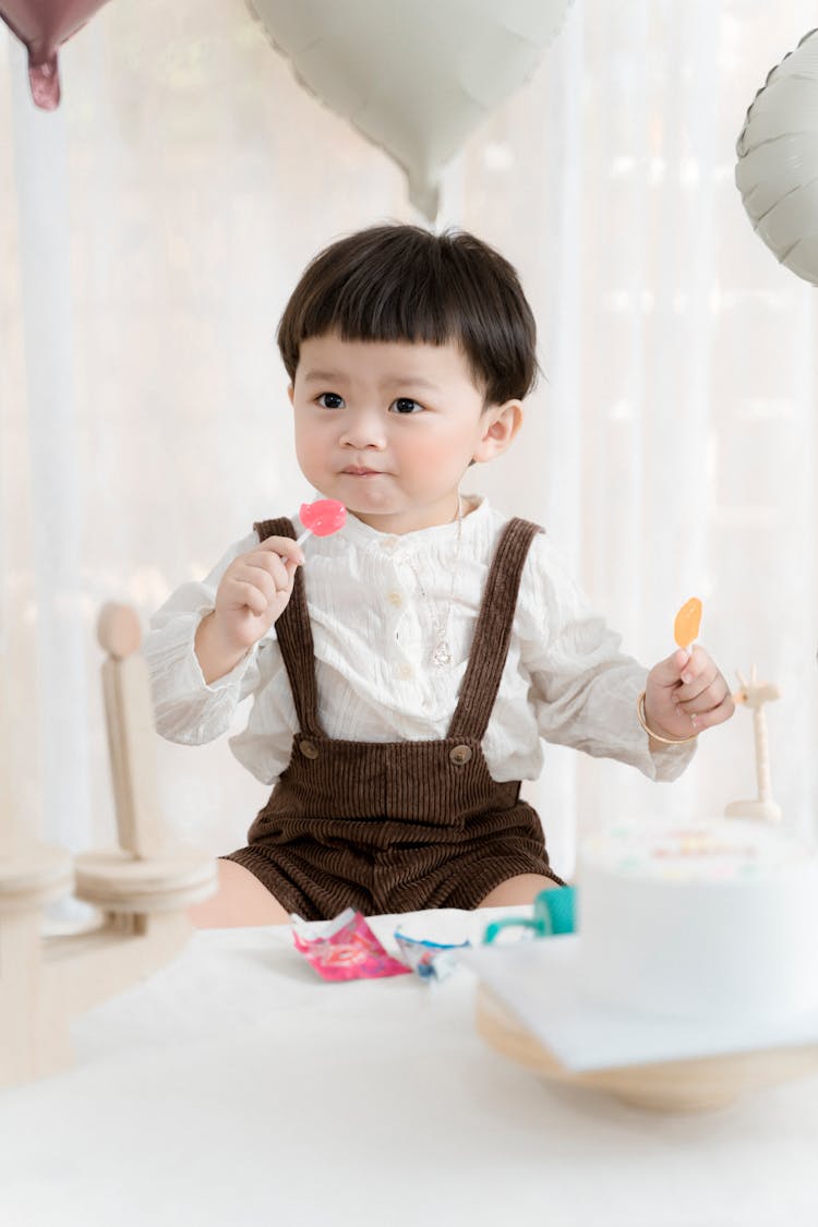 Boy Eating Lollipops