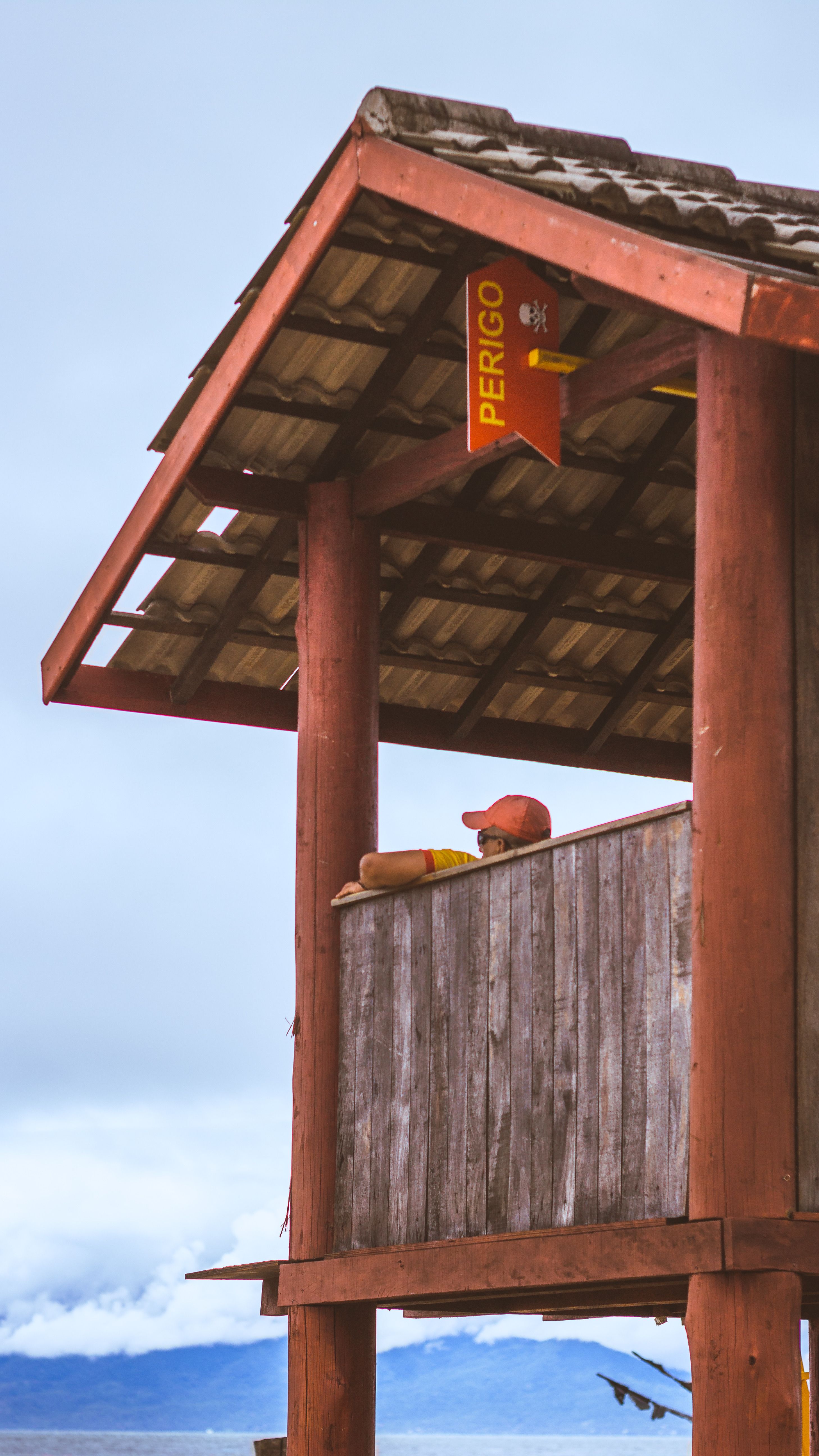 A Woman Standing Beside a Lifeguard Post · Free Stock Photo