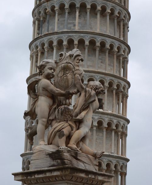 Free Renaissance sculpture at the base of the iconic Leaning Tower of Pisa. Stock Photo