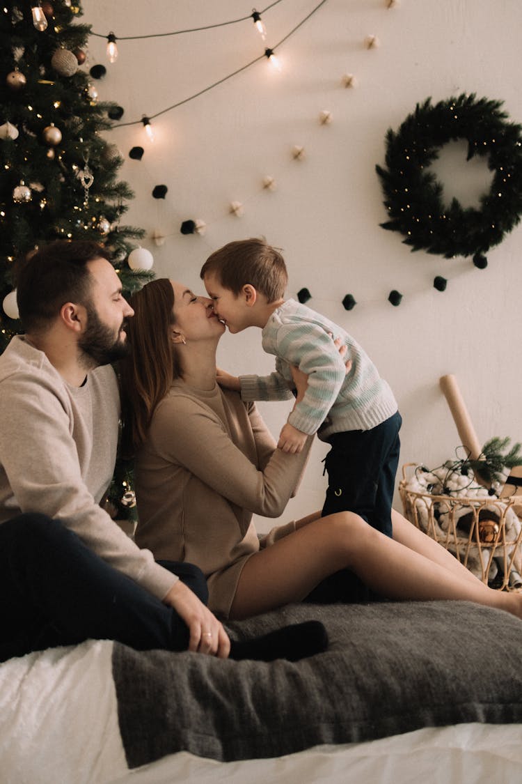 Smiling Mother, Father And Son In Room