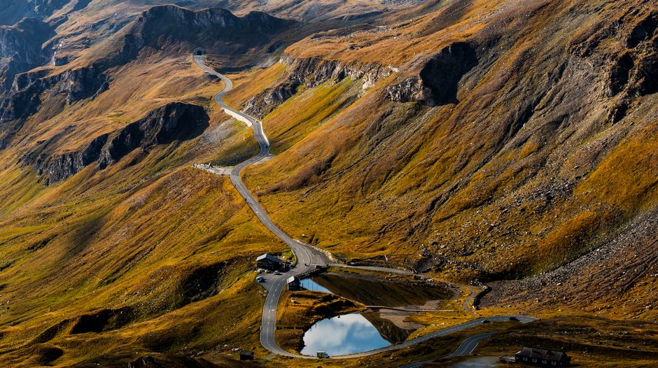 Aerial view of a winding road through mountain landscapes in Salzburg, Austria.