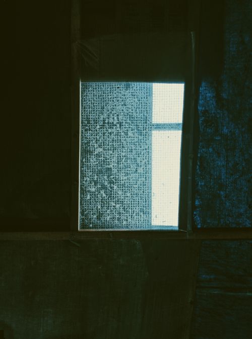 Free Explore the intriguing aesthetics of an abandoned Indonesian building through a moody window view. Stock Photo