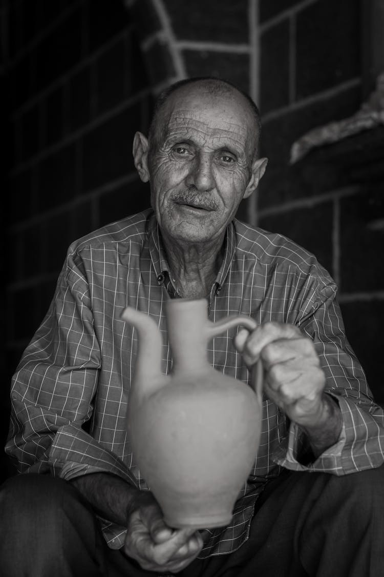 Man Holding Ceramic Vase