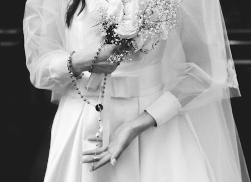 Flowers in Woman Hands in Wedding Dress