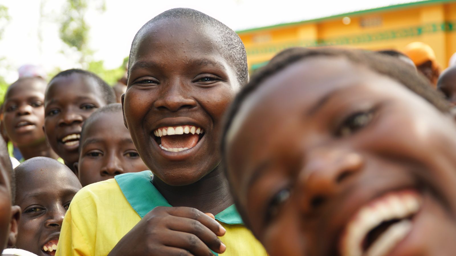 Cheerful group of children in Uganda smiling outdoors