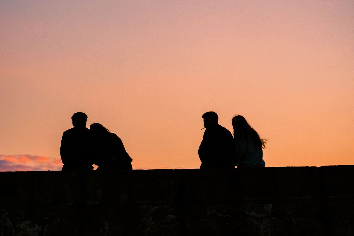 Silhouetted group watching a sunset together — photo by Ayşegül Aytören on Pexels
