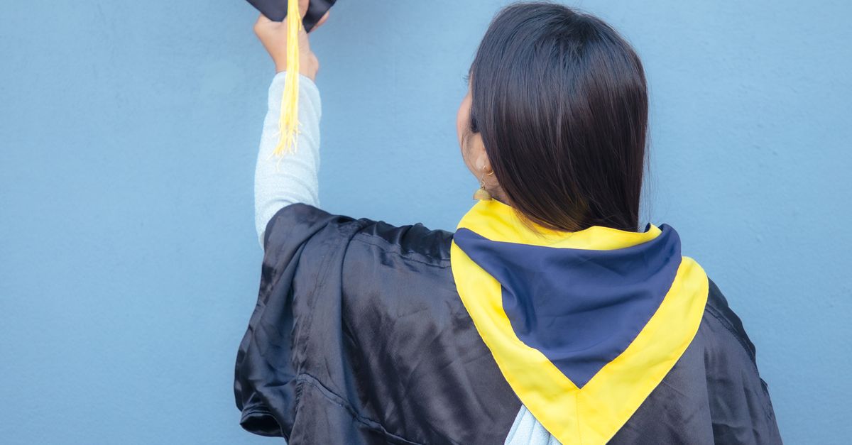 Graduation Robe Full Back View Back View of a Woman Wearing Black Graduation Gown while Holding a ...