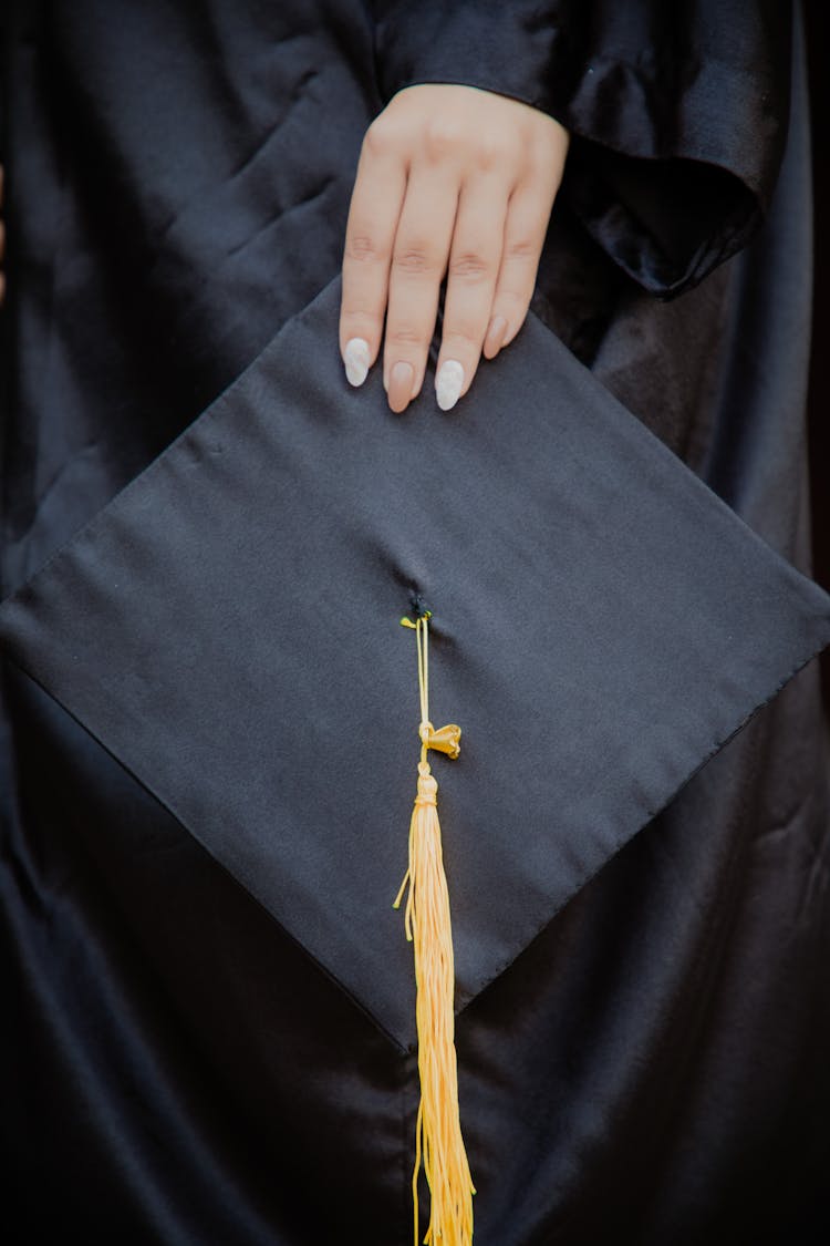 A Person Holding A Graduation Cap