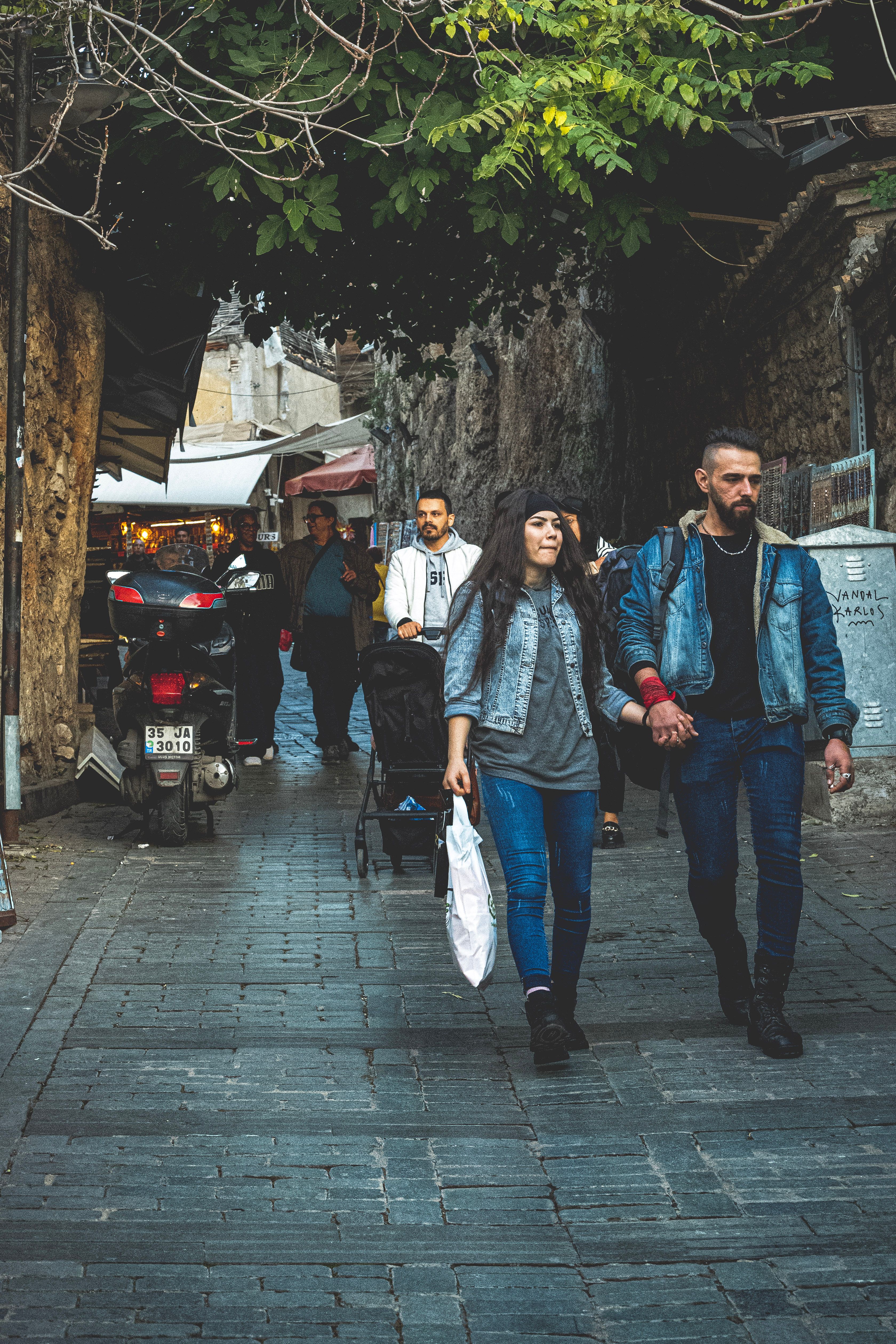 Couple Holding Hands Walking on Pavement under Trees · Free Stock Photo