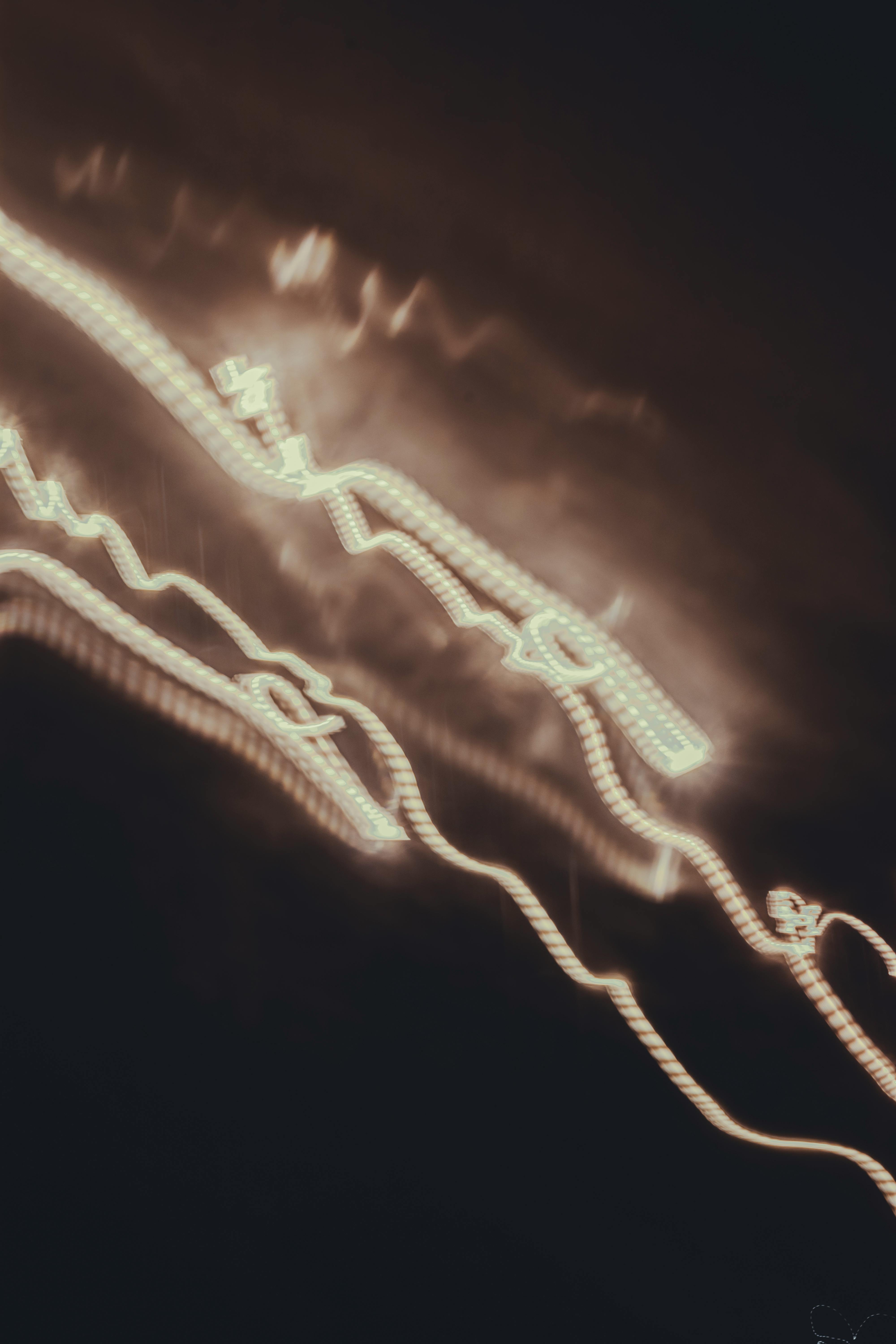 Streaks of white light creating abstract patterns against a dark backdrop.