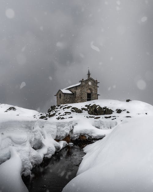 A Cathedral on a Snow Covered Landscape Under Gray Sky