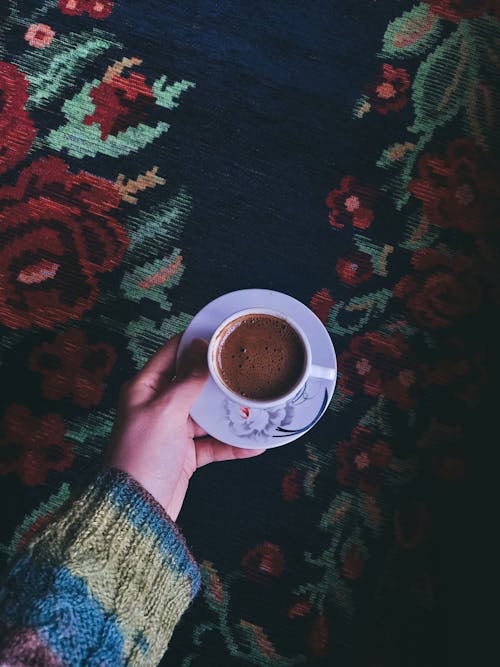 Free A Person Wearing Knitted Sweater Holding a Saucer with Cup Hot Chocolate Drink Stock Photo