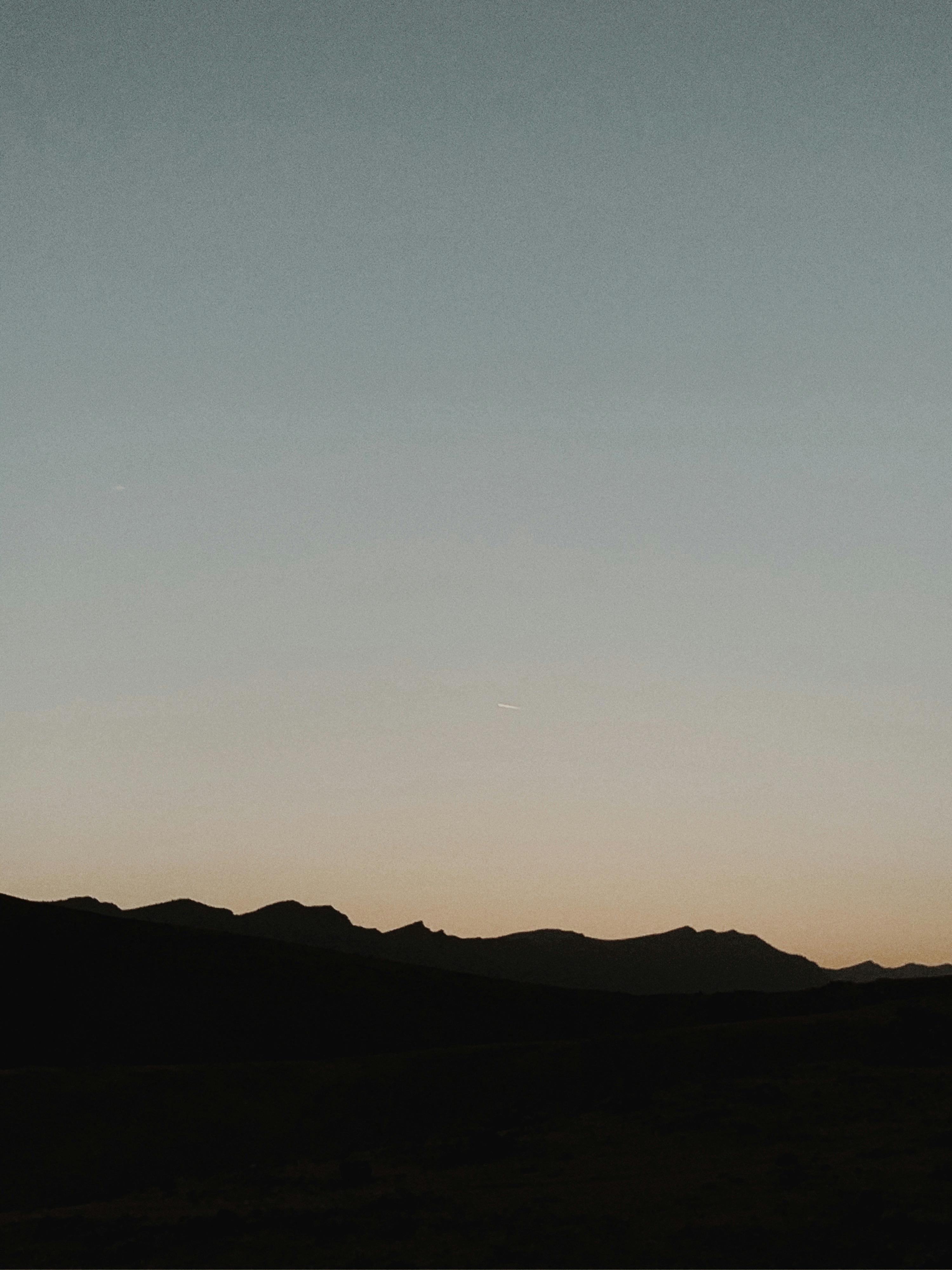 Free A calm twilight sky above the mountain silhouettes in Ranya, Iraq. Stock Photo