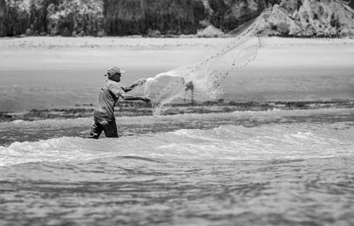 Grayscale Photo Of Man Fishing