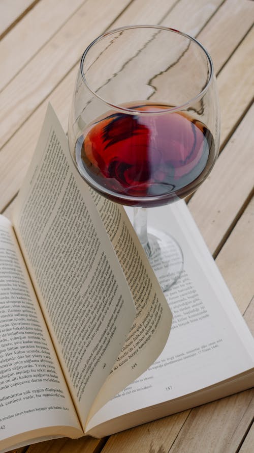 A Glass of Red Wine on a Book 