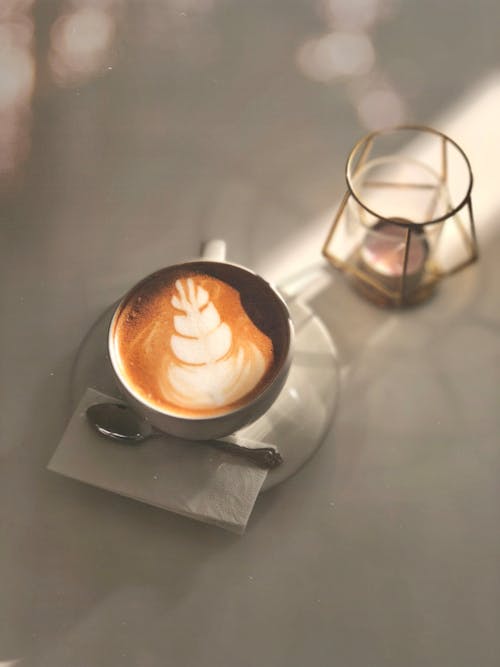 Close-Up Shot of a Latte Art Coffee in White Ceramic Cup