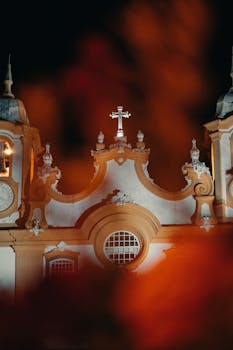 Illuminate church facade in Tiradentes, Brazil, showcasing Baroque architecture and vibrant lighting effects.