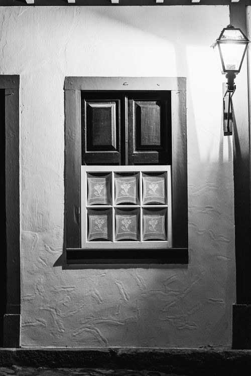 Free Black and white photo of a colonial style window and street lamp in Tiradentes, Brazil. Stock Photo