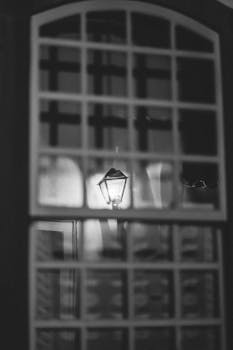Artistic window reflection in Tiradentes with street lamp at night.
