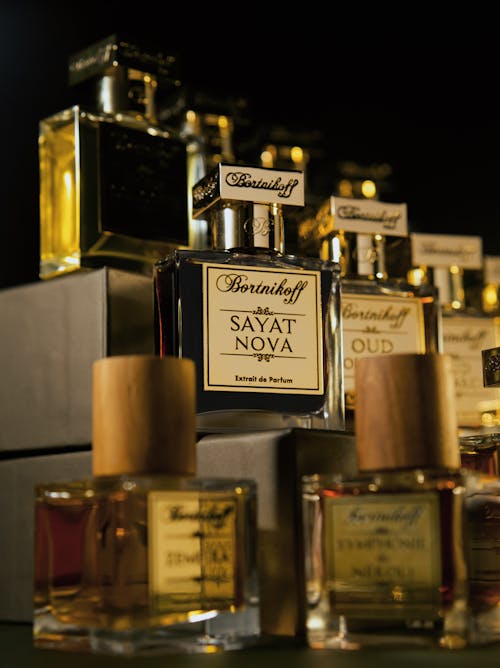 Bottles of Perfumes Displayed on Black Ba