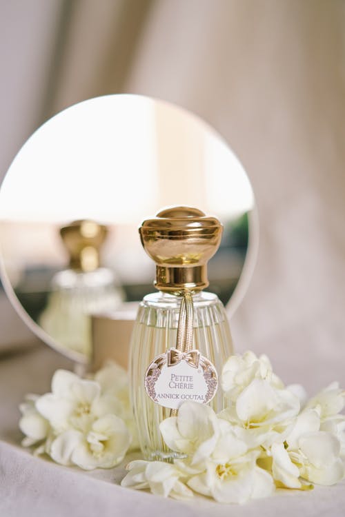 Bottle of Perfume in Front of a Mirror