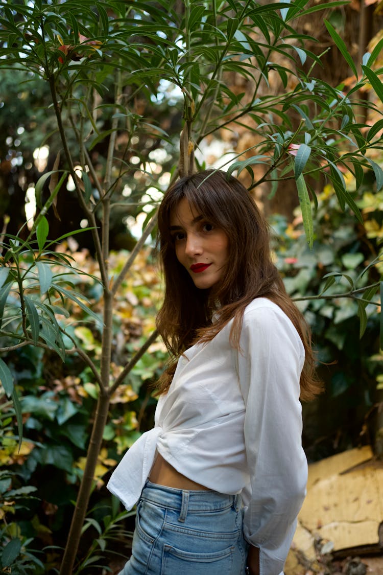 Woman Posing By A Tree