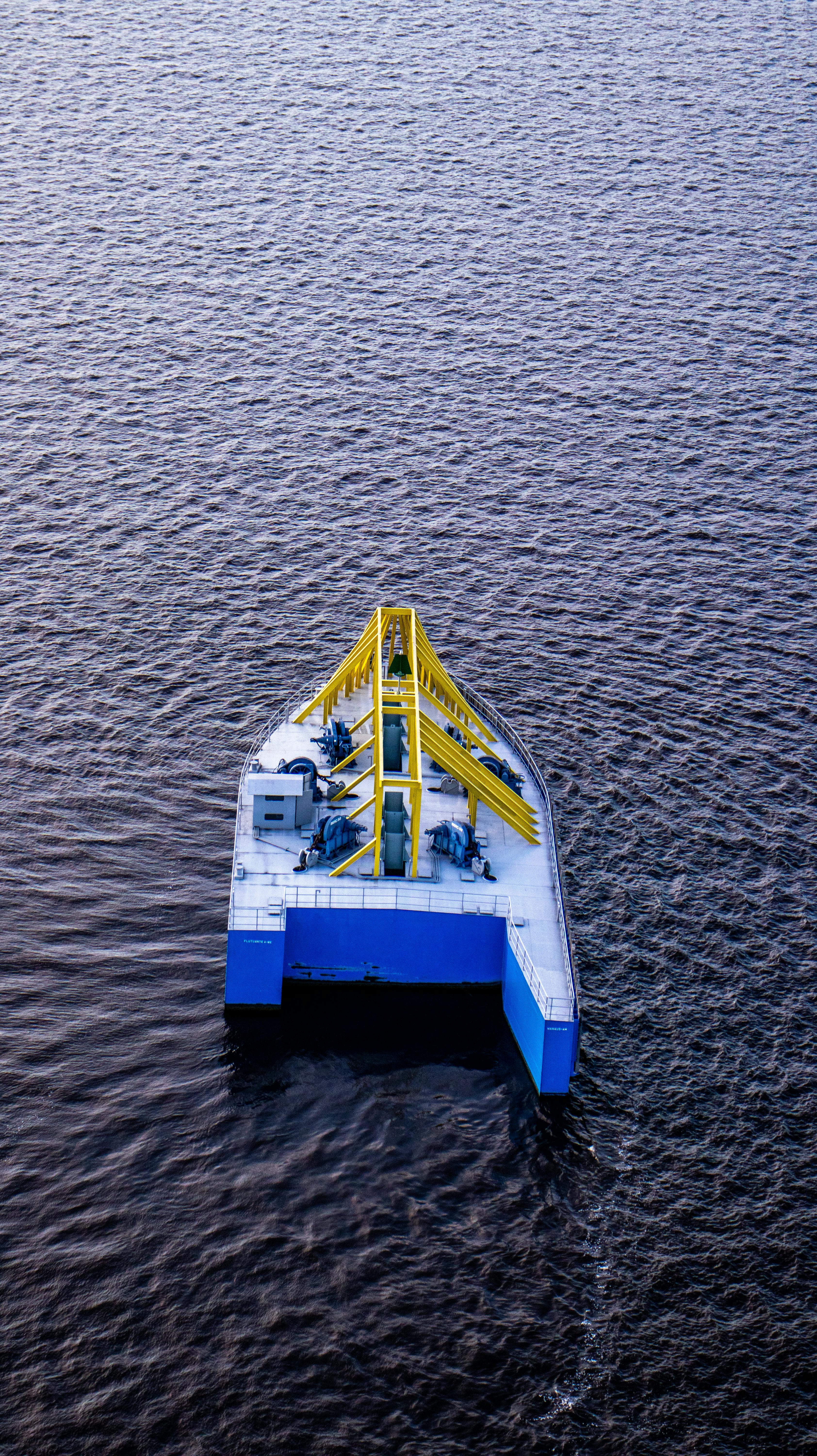 an aerial view of a small boat in the water