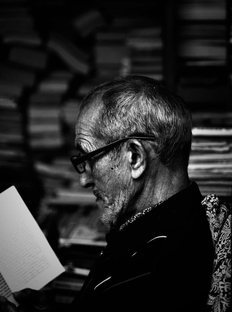 Old Man In Glasses Reading Book
